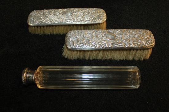 George V silver four piece dressing table set and a silver mounted toilet bottle
